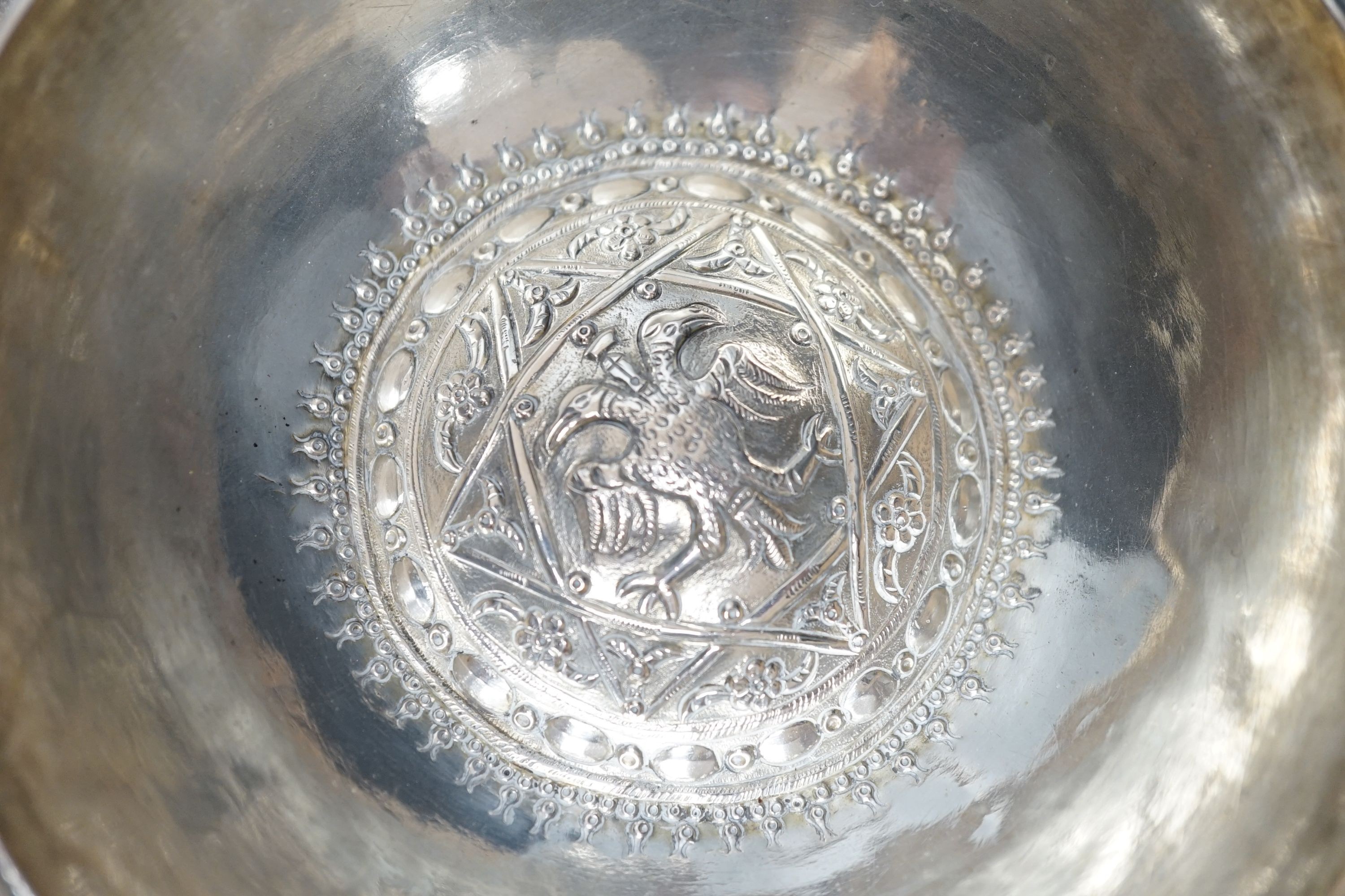 Four small Rangoon white metal bowls together with a simile basket and six small white metal bowls with heraldic motifs, gross 24.5oz.